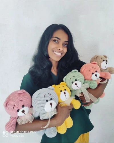 a-young-girl-holding-a-bunch-of-teddy-bears-Yle20Zk8llH0NngQ